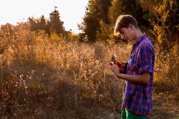 Man playing ukulele medium shot