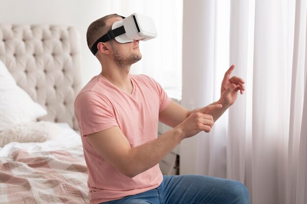 Man playing videogames while wearing virtual reality goggles