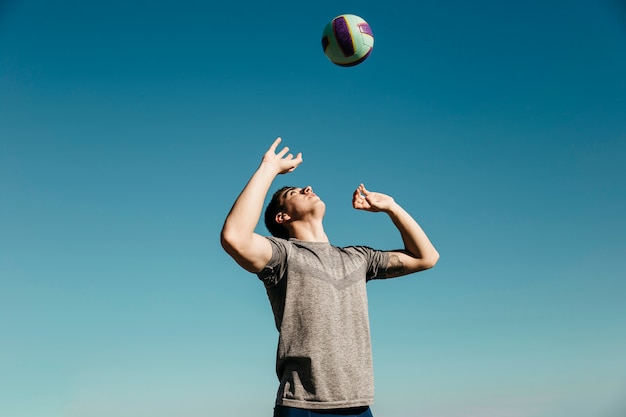 Man playing volleyball at the beach