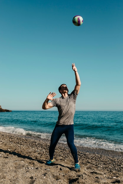 Man playing volleyball at the beach