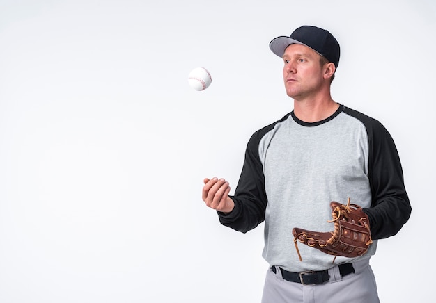 Man playing with baseball and holding glove