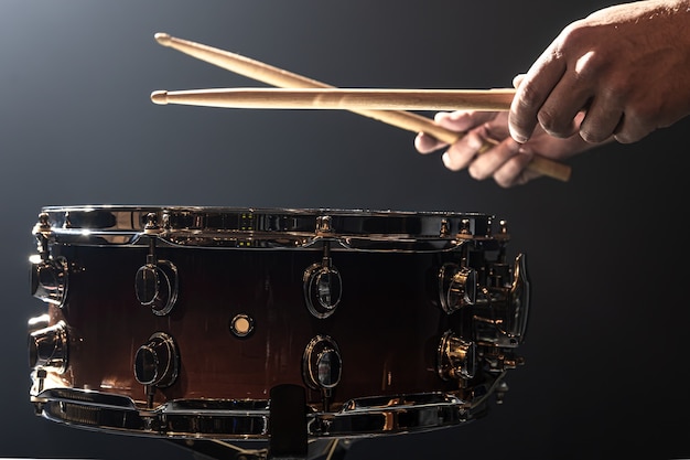 Free Photo a man plays with sticks on a drum, a drummer plays a percussion instrument, copy space.