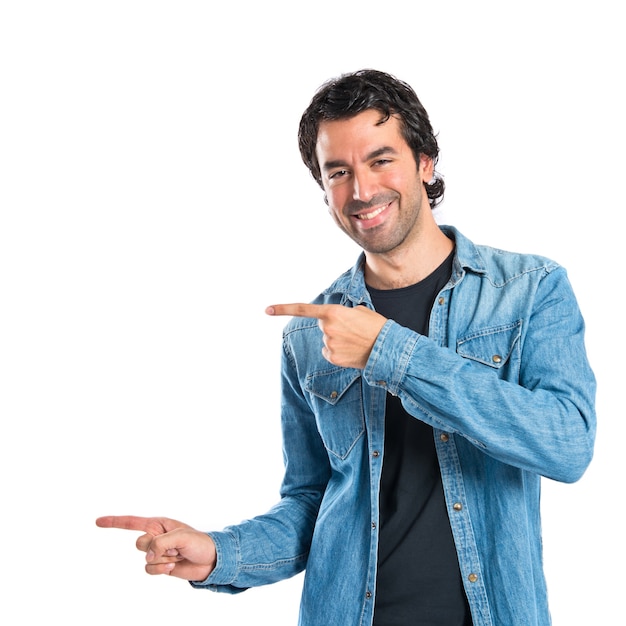 Man pointing lateral over white background