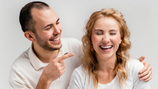 Free Photo man pointing at woman laughing