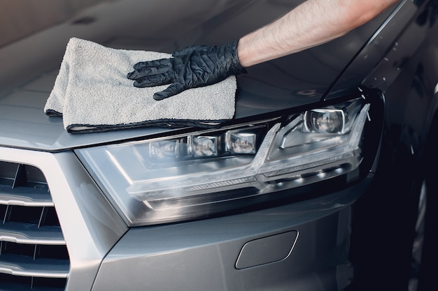 Man polish a car in a garage