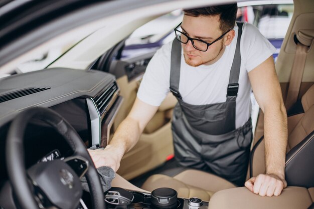 Man polishing car inside at car service