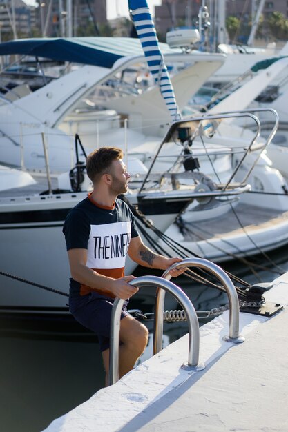 a man in the port preparing the yacht for the trip