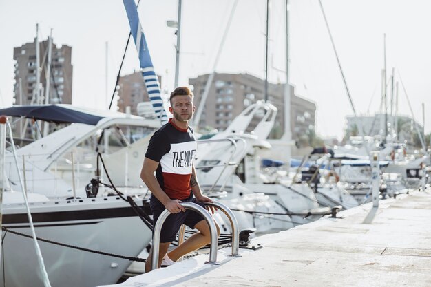 a man in the port preparing the yacht for the trip