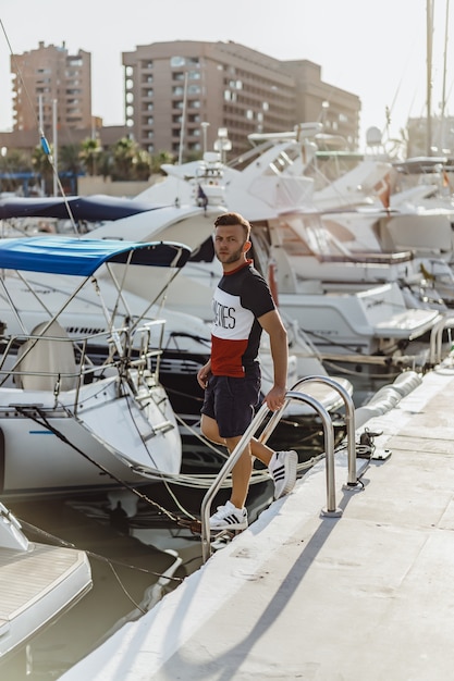 Free Photo a man in the port preparing the yacht for the trip