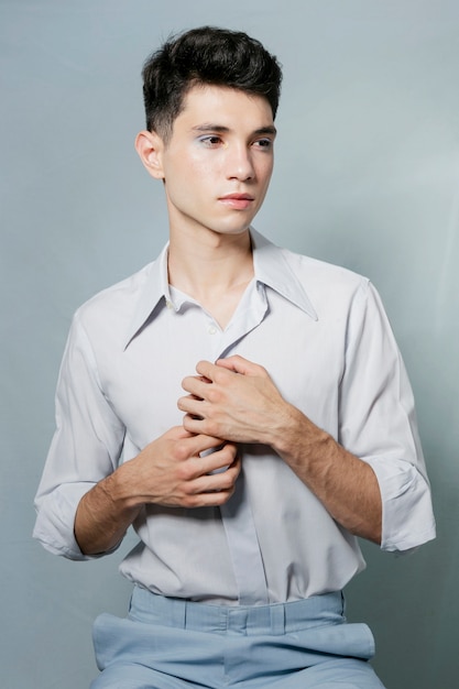 Man posing and holding shirt