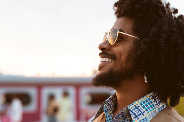 Man posing in retro style outdoors with sunglasses