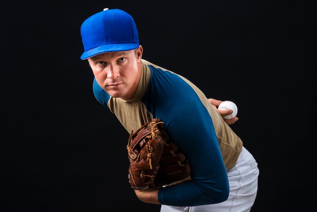 Free Photo man posing with baseball glove and ball