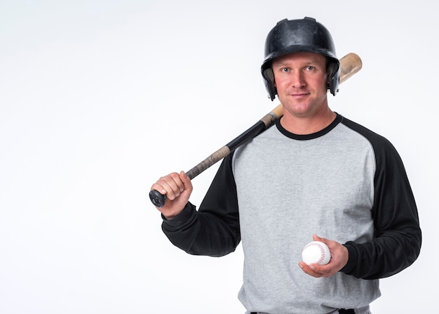 Man posing with baseball hat and ball