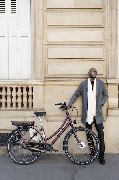 Man posing with a bike in the city in france