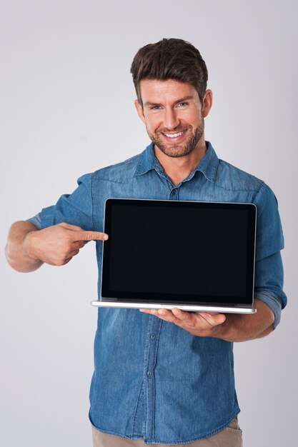 man posing with denim shirt and laptop