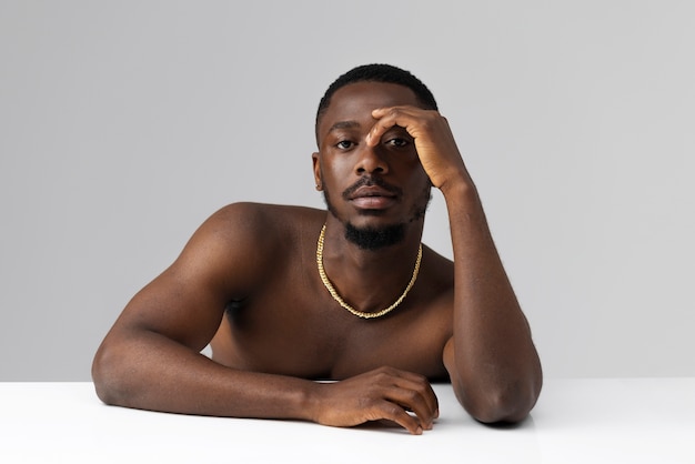 Man posing with necklace front view