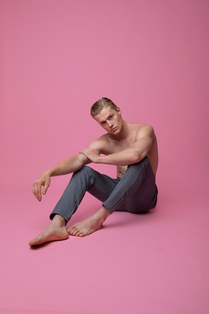 Free Photo man posing with pink background full shot