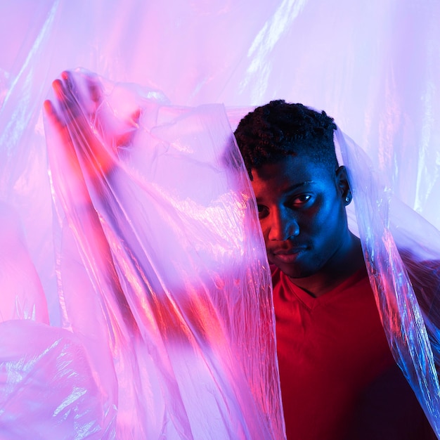 Free photo man posing with plastic foil