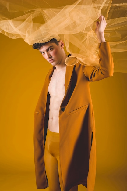 Free photo man posing with yellow cloth