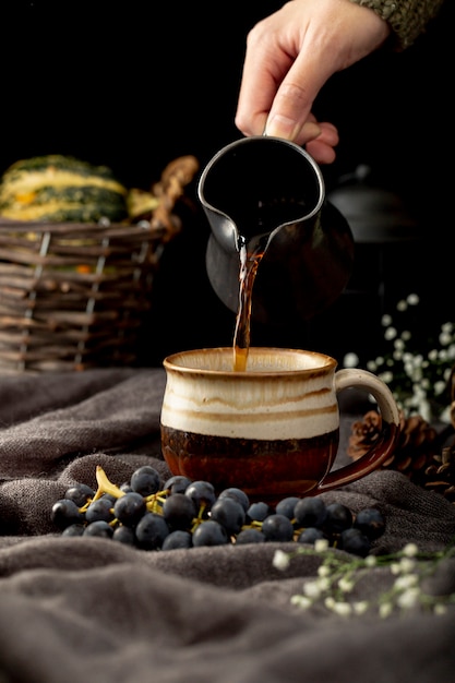 Man pouring coffee in a brown cup