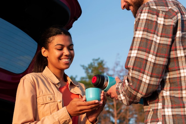 Man pouring coffee for his girlfriend