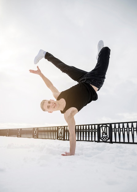 Free Photo man practicing hip hop outside in the snow