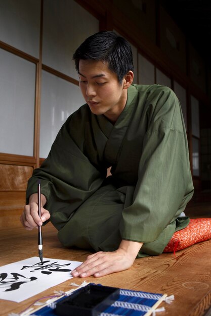 Man practicing japanese handwriting