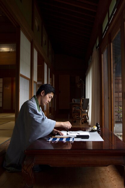 Man practicing japanese handwriting