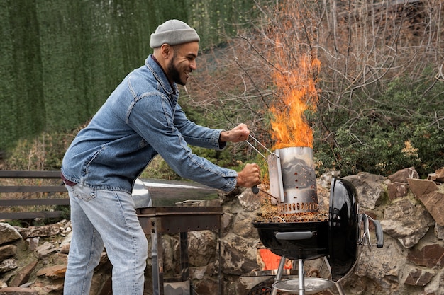 Free Photo man preparing barbeque for cooking