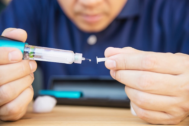 Free Photo man preparing insulin diabetic syringe for injection