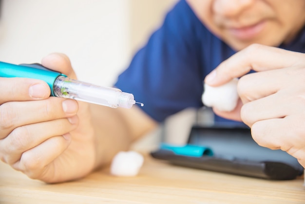 Man preparing insulin diabetic syringe for injection