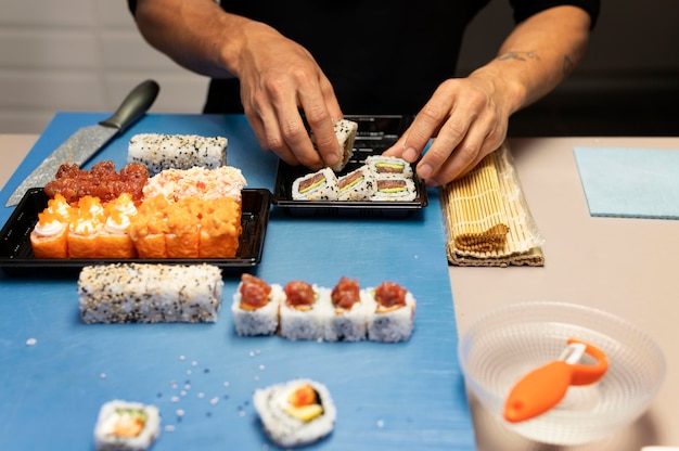 Free Photo man preparing a sushi order for a takeaway