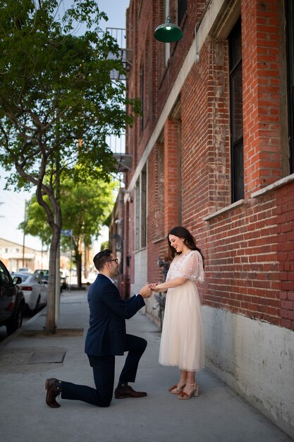 Man proposing to woman outdoors in the street