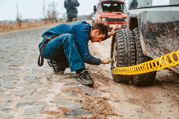 Free photo a man pumps air wheel with a compressor