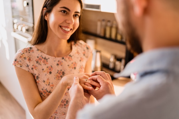 Free photo man puts the ring on his girlfriends finger