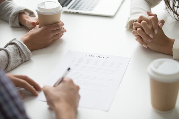 Man puts signature on contract, customers sign document concept, closeup