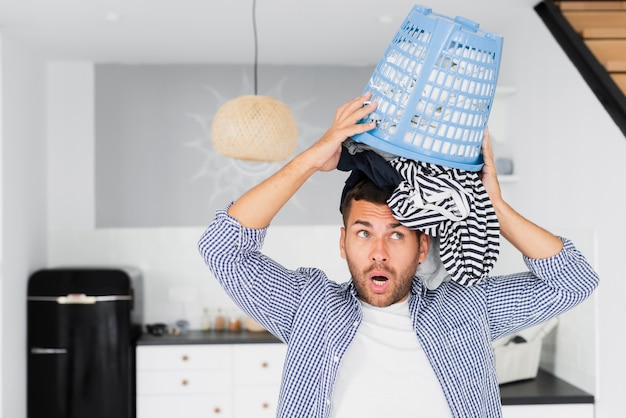 Free Photo man putting on head basket with clothes