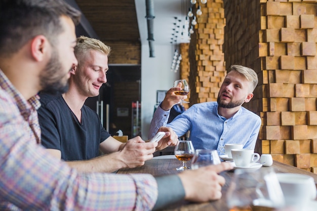 Free Photo man raising toast with his friends in the restaurant