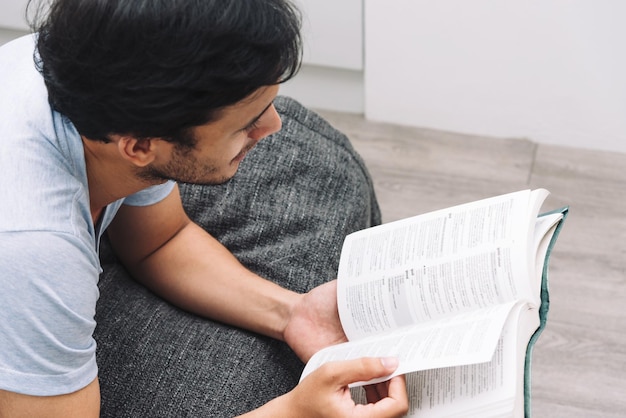 Man reading a book in bedroom university life