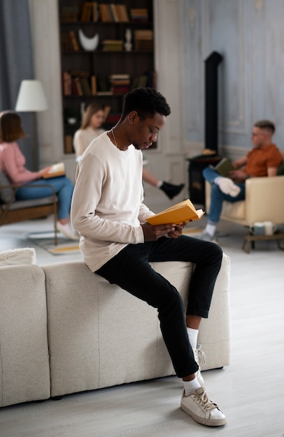 Free photo man reading a book at the reading club or library