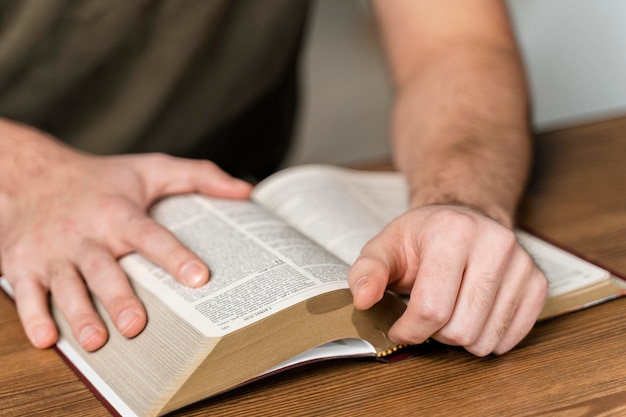 Man reading from the bible on the table