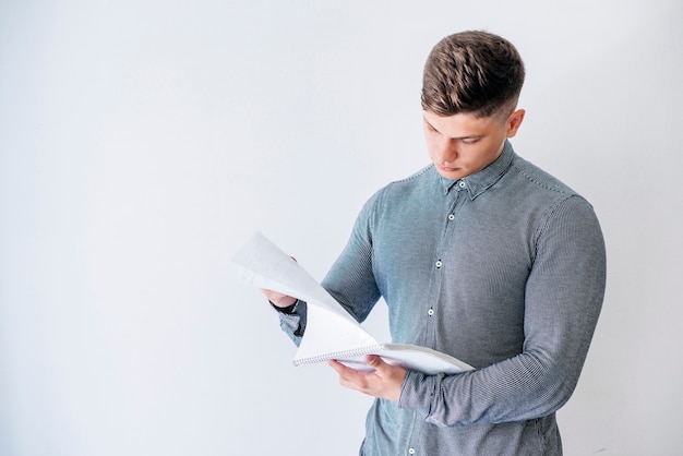 Man reading from notebook in studio