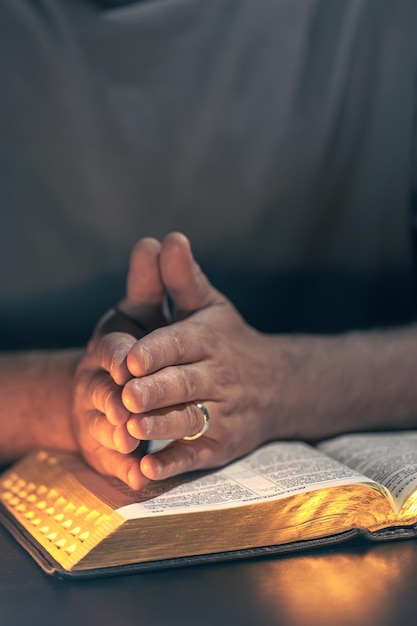 Free Photo a man reads the bible male hands with bible closeup