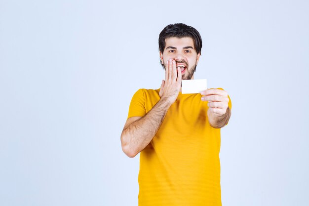 Man receiving the business card of a partner and getting surprised.