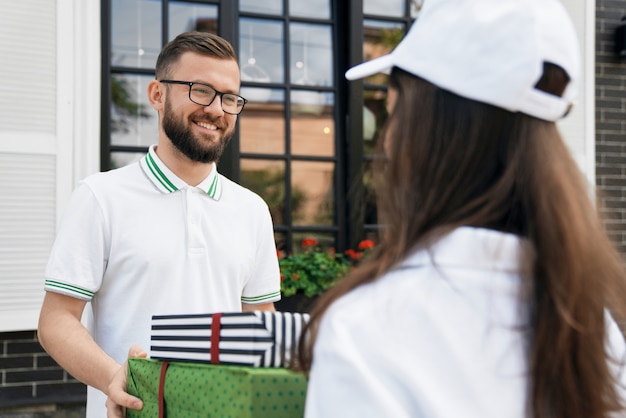 Man receiving gift boxes from courier