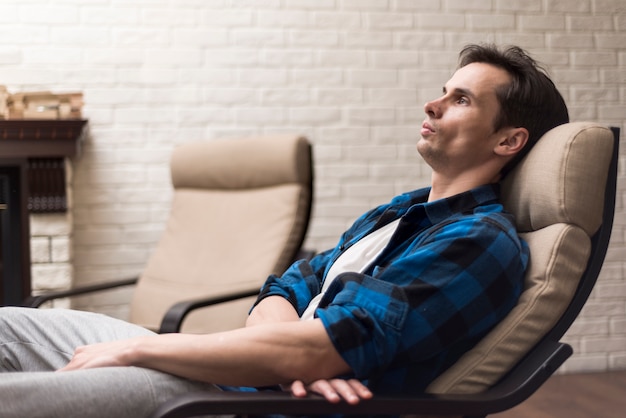 Free photo man relaxing on a rocking chair