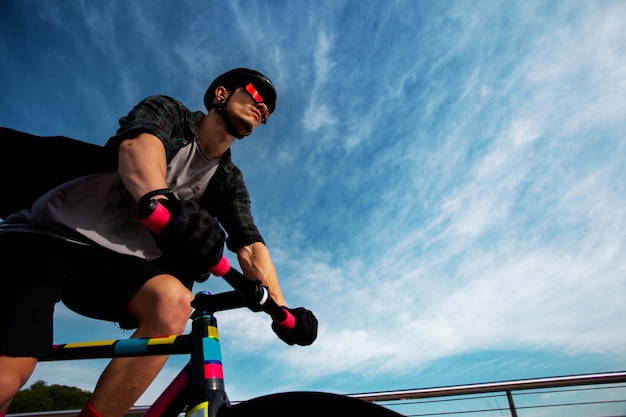 Man ride a bicycle at bridgeThe image of cyclist in motion on the background in the morning