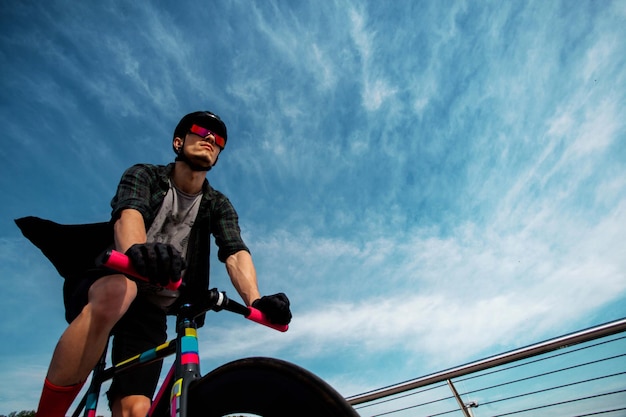 Man ride a bicycle at bridgeThe image of cyclist in motion on the background in the morning