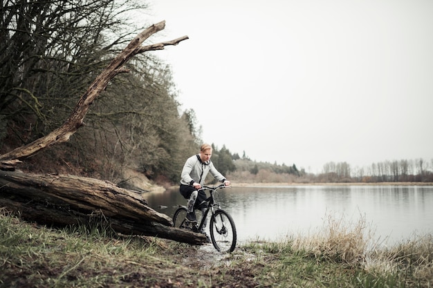 Man riding bicycle near the lake