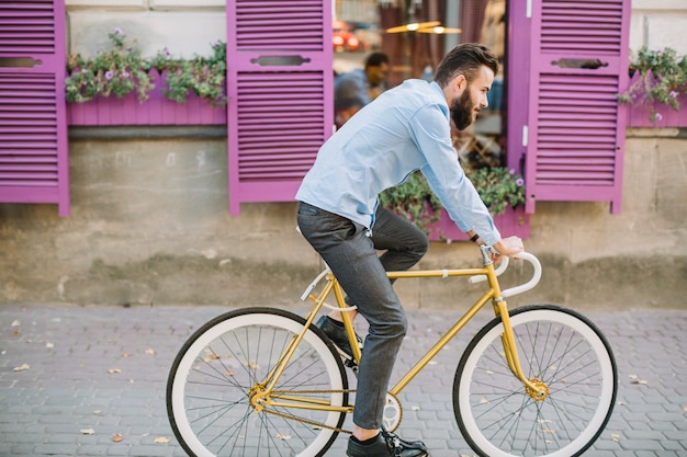 Man riding bicycle and talking on phone